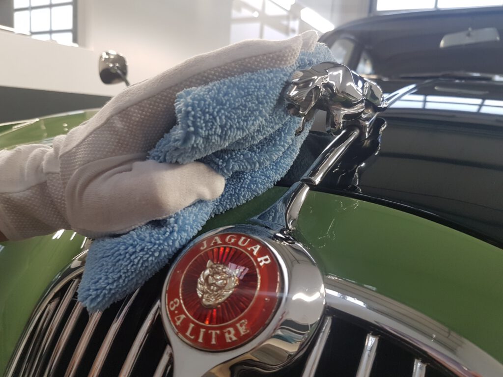 Jaguar Oldtimer, Kühlerfigur wird poliert